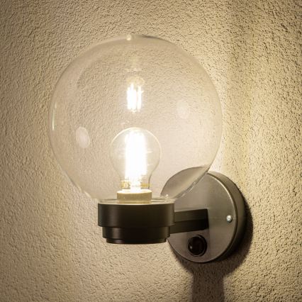 BRILAGI - Уличный настенный светильник HARBOR с датчиком движения 1xE27/40W/230V IP33 черный/прозрачный