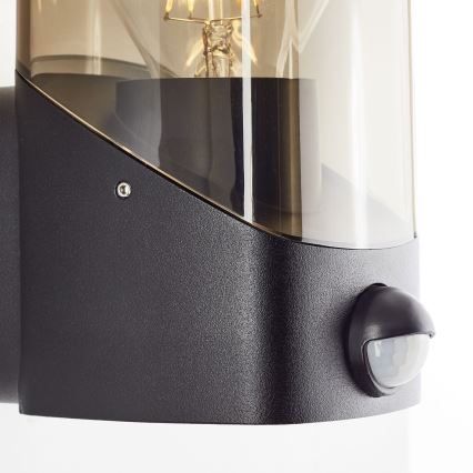 Brilliant - Вуличний настінний світильник з датчиком MINOU 1xE27/10W/230V IP44 чорний/димчастий