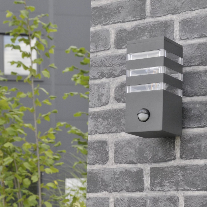 Настенный уличный светильник с датчиком TEKSAS 1xE27/12W/230V IP44 антрацит