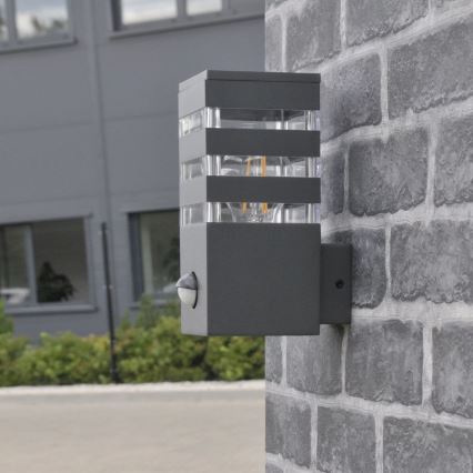 Вуличний настінний світильник з датчиком TEKSAS 1xE27/12W/230V IP44 антрацит
