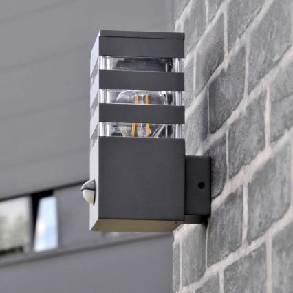 Вуличний настінний світильник з датчиком TEKSAS 1xE27/12W/230V IP44 антрацит